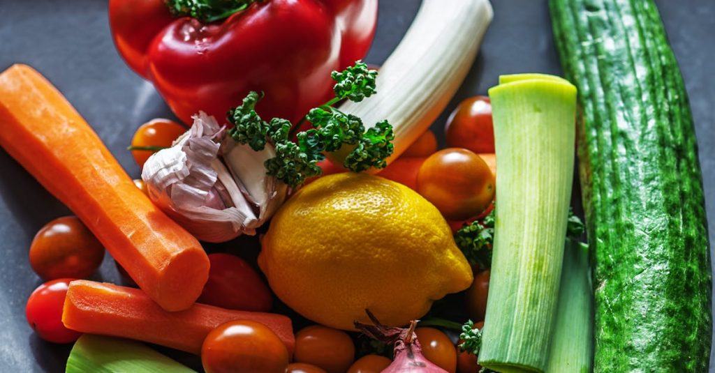 A vibrant flat lay of fresh vegetables and ingredients including peppers, leeks, and lemon.