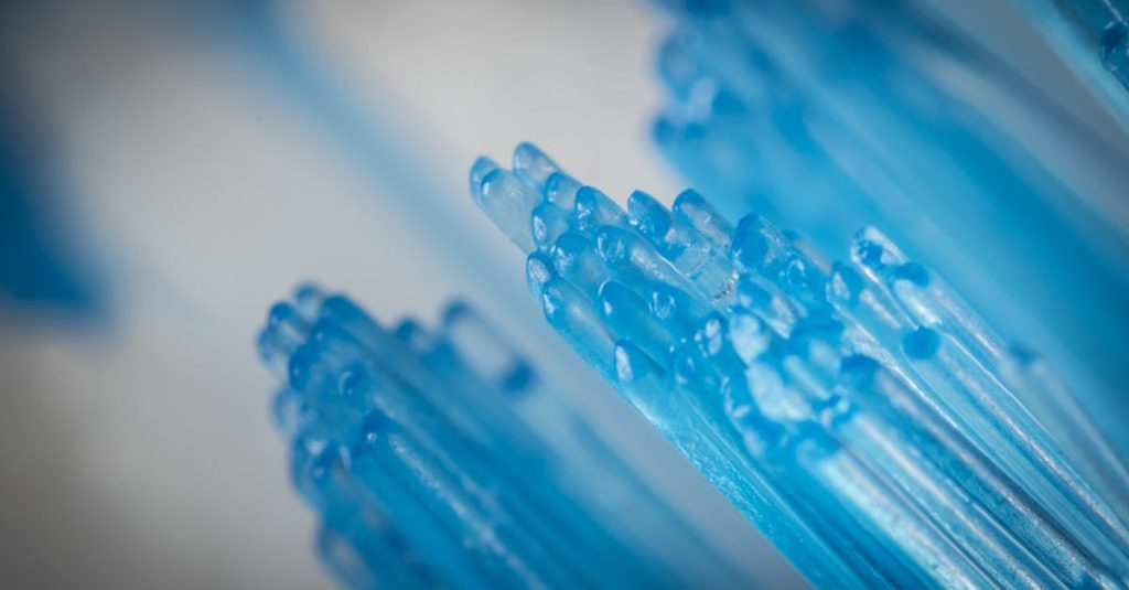Close-up of blue toothbrush bristles, capturing intricate details and textures.